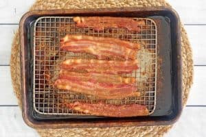 baked bacon on a wire rack over a baking sheet.