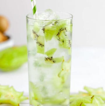 homemade Starbucks kiwi starfruit refresher drink and sliced fruit.