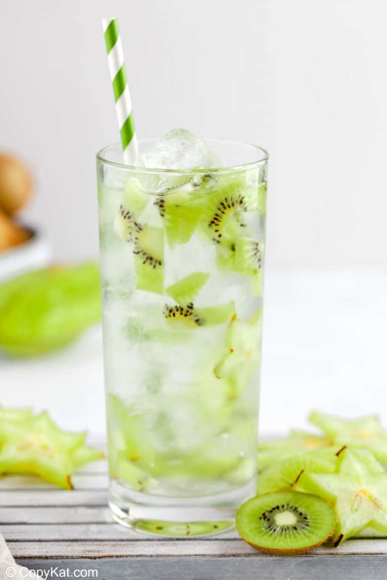 homemade Starbucks kiwi starfruit refresher drink and sliced fruit.
