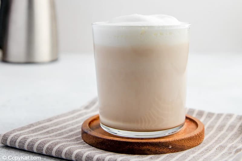 homemade Starbucks London Fog tea latte on a wood coaster.