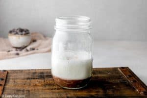 steamed milk and chocolate ganache in a glass jar.