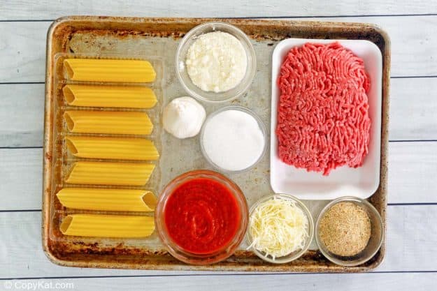 stuffed manicotti ingredients on a baking sheet.