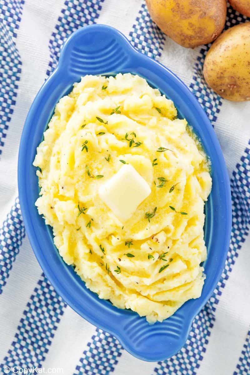 overhead view of yukon gold mashed potatoes in a serving dish.