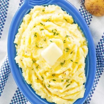 overhead view of yukon gold mashed potatoes in a serving dish.