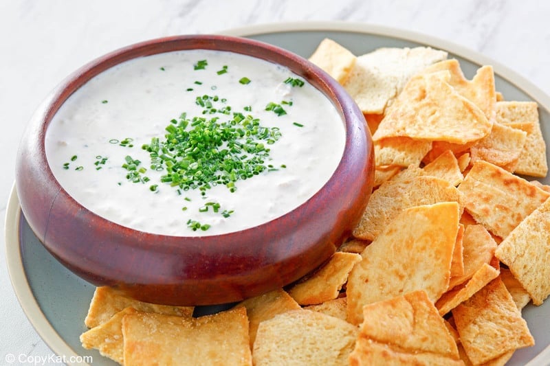 clam dip and crackers on a round platter.