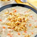 creamy turkey soup topped with stuffing in a bowl.