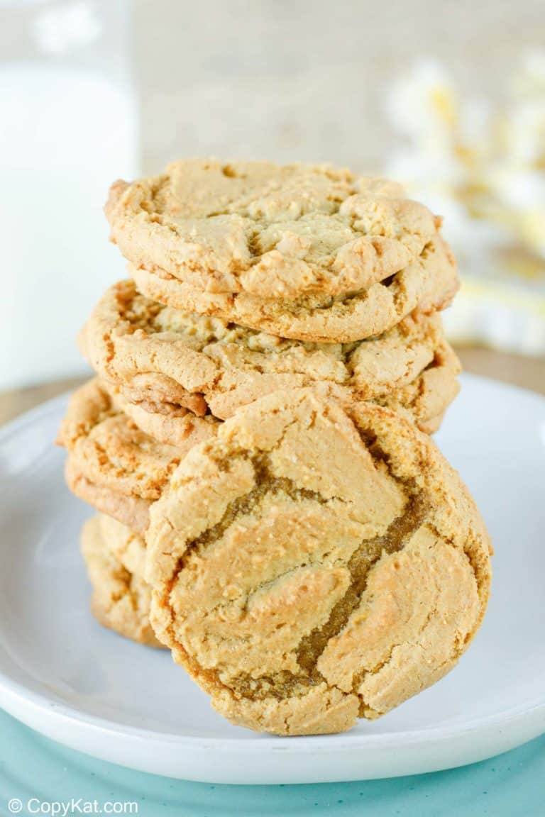 homemade gingersnap cookies stacked on a plate.