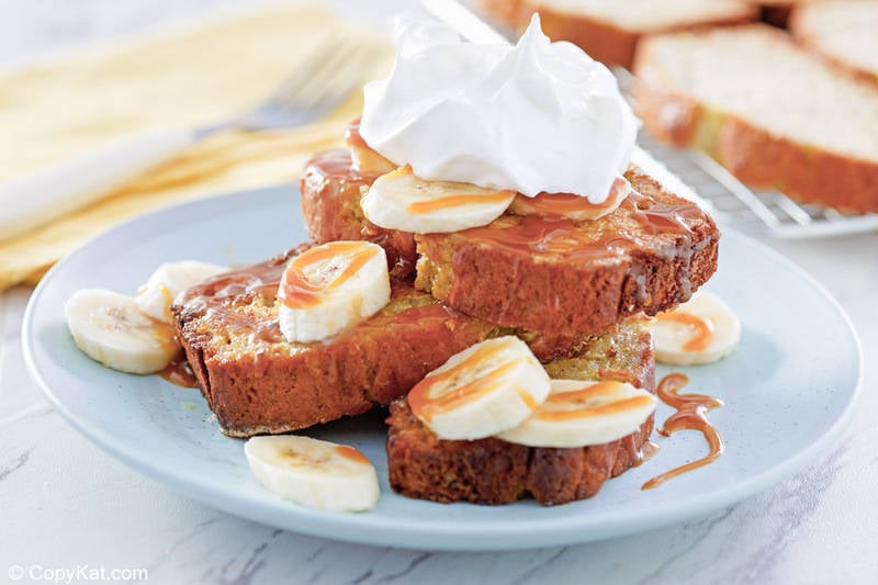 homemade IHOP Banana Bread French Toast with bananas, caramel sauce, and whipped cream.