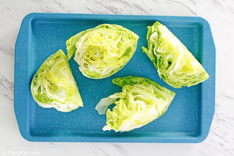 iceberg lettuce wedges on a tray.