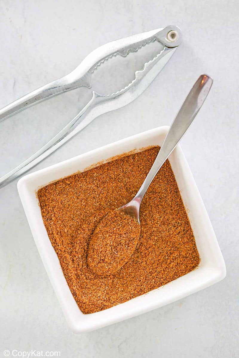 overhead view of homemade old bay seasoning in a small square bowl.