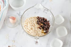 adding oats and raisins to cookie dough base.