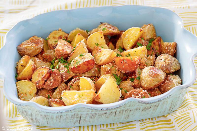 roasted parmesan potatoes in a rectangular serving dish.