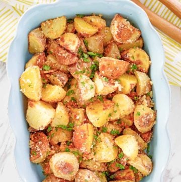 overhead view of parmesan potatoes in a serving dish.