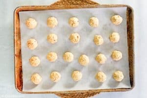 pecan sandies cookie dough balls on a baking sheet before baking.