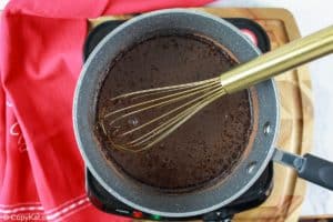 cooking peppermint chocolate syrup in a pan.