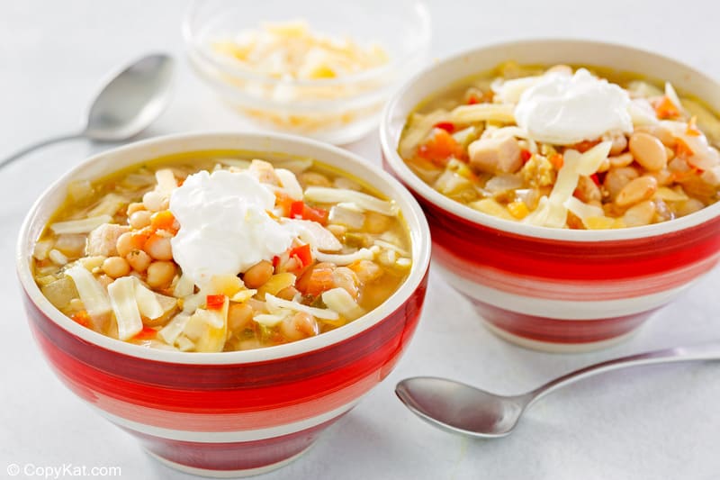 homemade Ruby Tuesday white chicken chili in two bowls and two spoons.