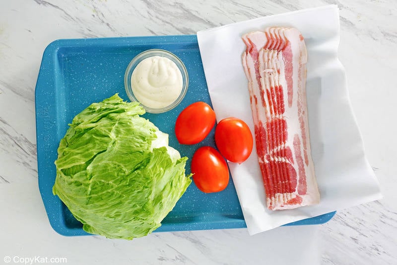 wedge salad ingredients on a tray.