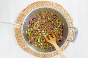 browned ground beef and chopped vegetables for American chop suey in a pan.
