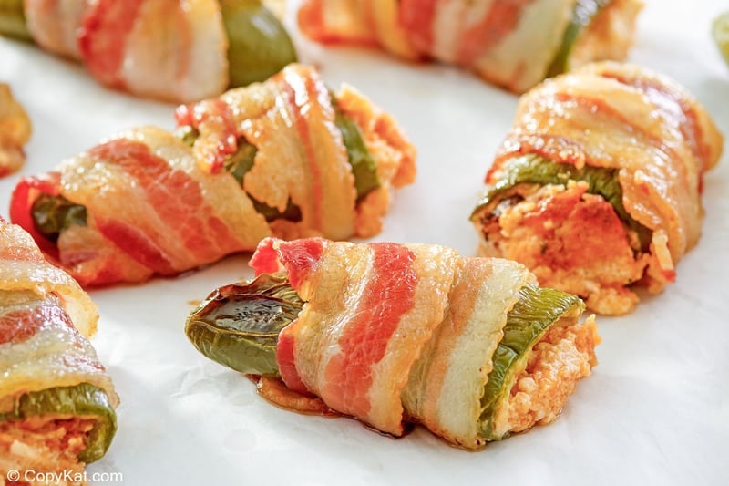 bacon wrapped jalapeno poppers with cheddar cream cheese filling.