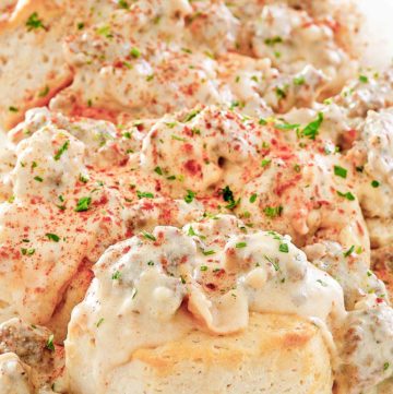 homemade Bob Evans Sausage gravy over biscuits on a platter.