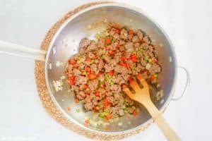 cooked sausage and vegetables in a pan.