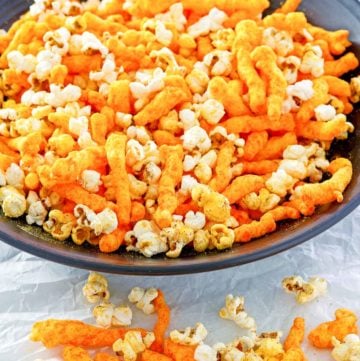 homemade Cheetos popcorn in a big black bowl.