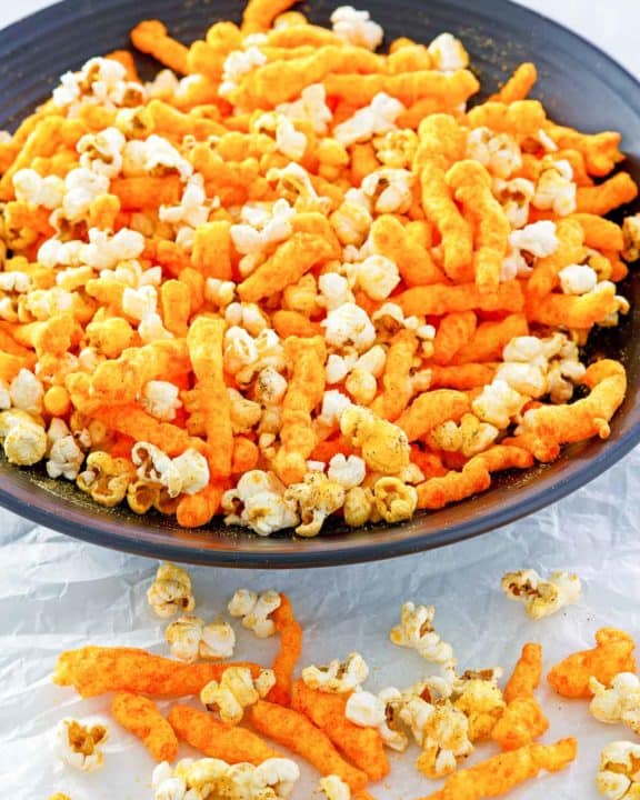homemade Cheetos popcorn in a big black bowl.