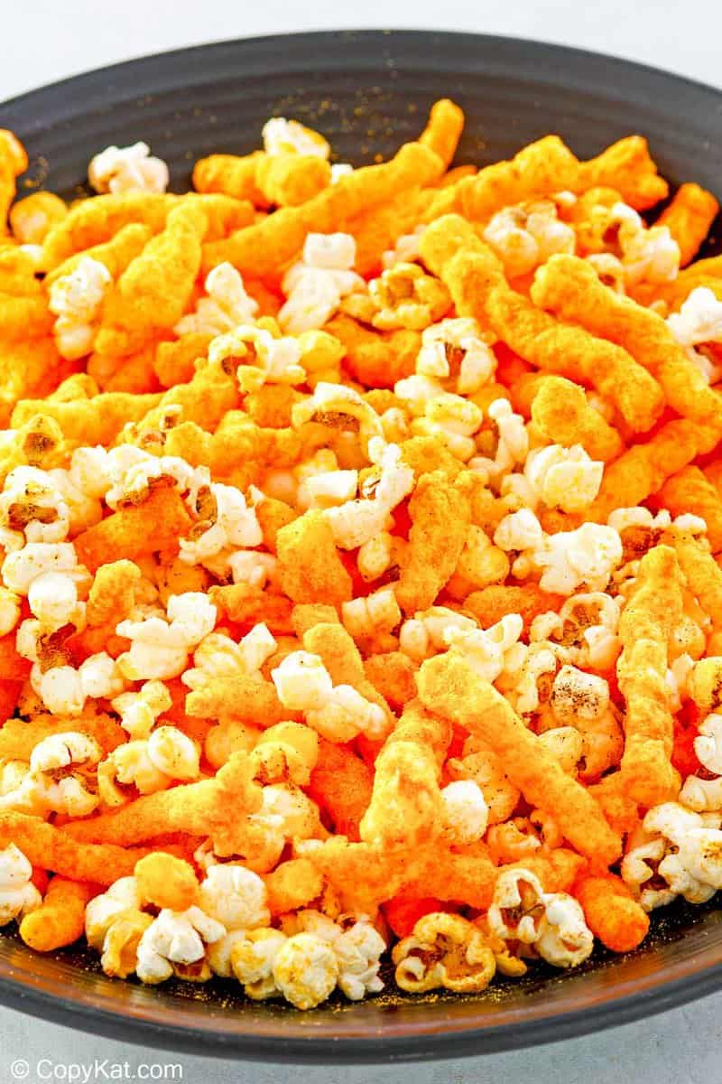 overhead view of homemade Cheetos popcorn in a bowl.