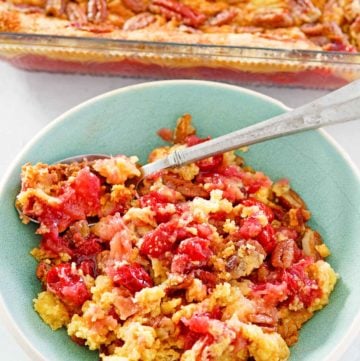 cherry pineapple dump cake in a baking dish and a serving in a bowl.