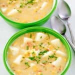 two bowls of corn chowder with potatoes.