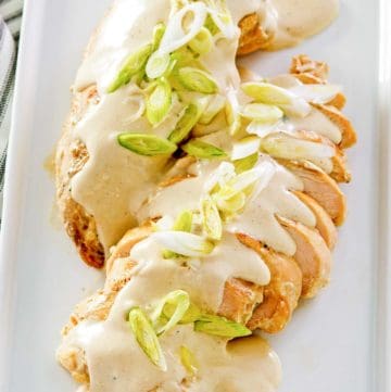 chicken with cream cheese sauce on a platter.