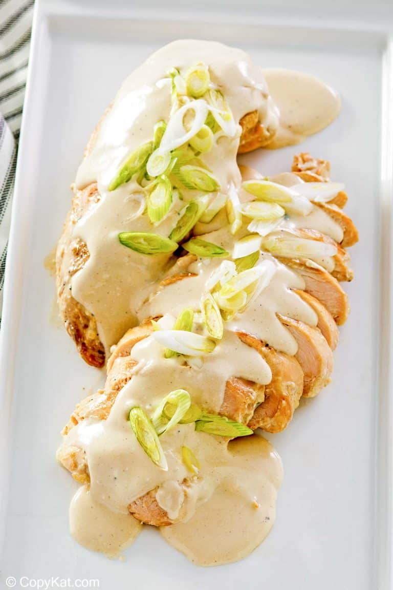 chicken with cream cheese sauce on a platter.