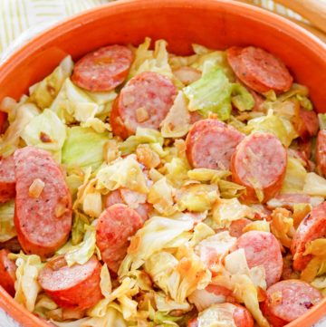 fried cabbage and sausage in a bowl.