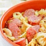 closeup of a bowl of fried cabbage and sausage