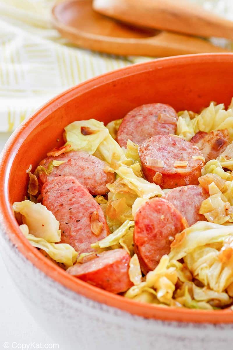 closeup of a bowl of fried cabbage and sausage