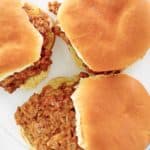 overhead view of loose meat sandwiches on a plate.