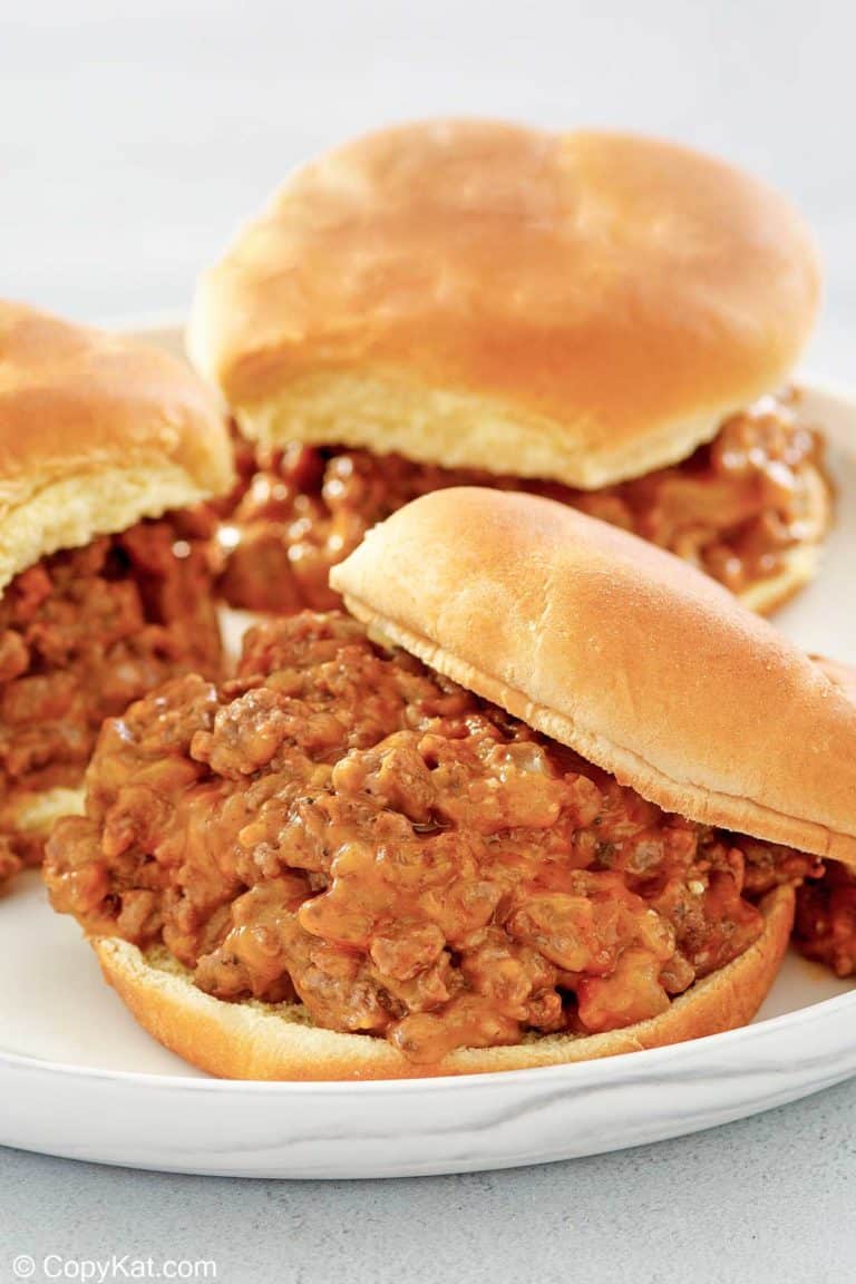 three loose meat sandwiches on a plate.