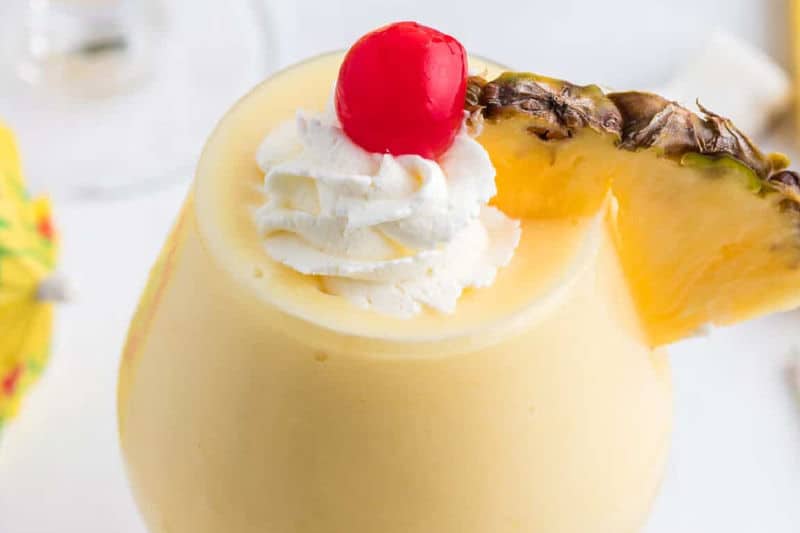 frozen pina colada cocktail garnished with pineapple.
