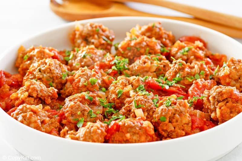 a bowl of porcupine meatballs with tomato sauce.