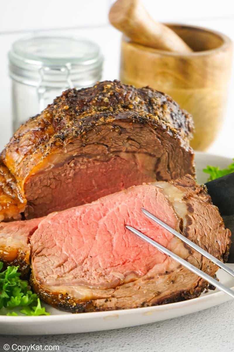 slicing a prime rib ribeye roast.