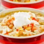 a bowl of homemade Ruby Tuesday white chicken chili with a dollop of sour cream on top.