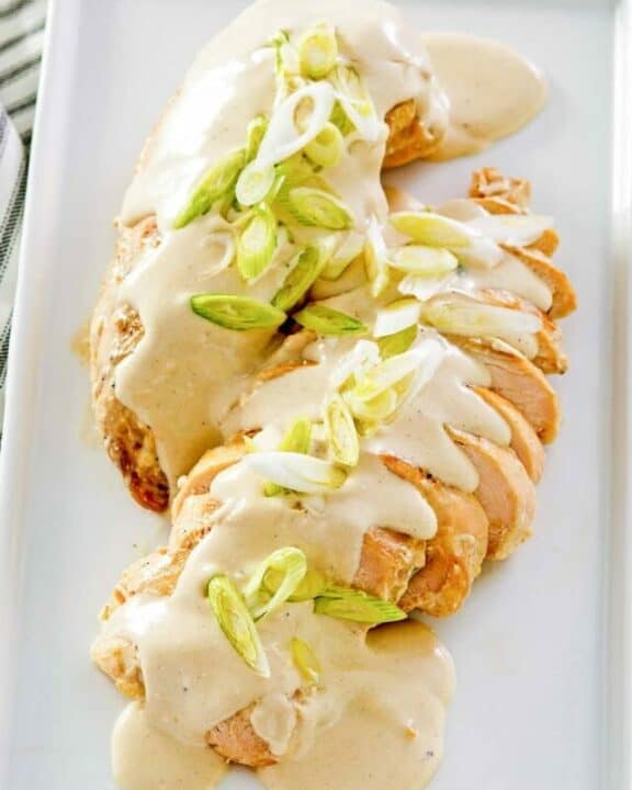 chicken with cream cheese sauce on a platter.