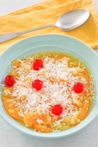 bowl of ambrosia fruit salad and a spoon.