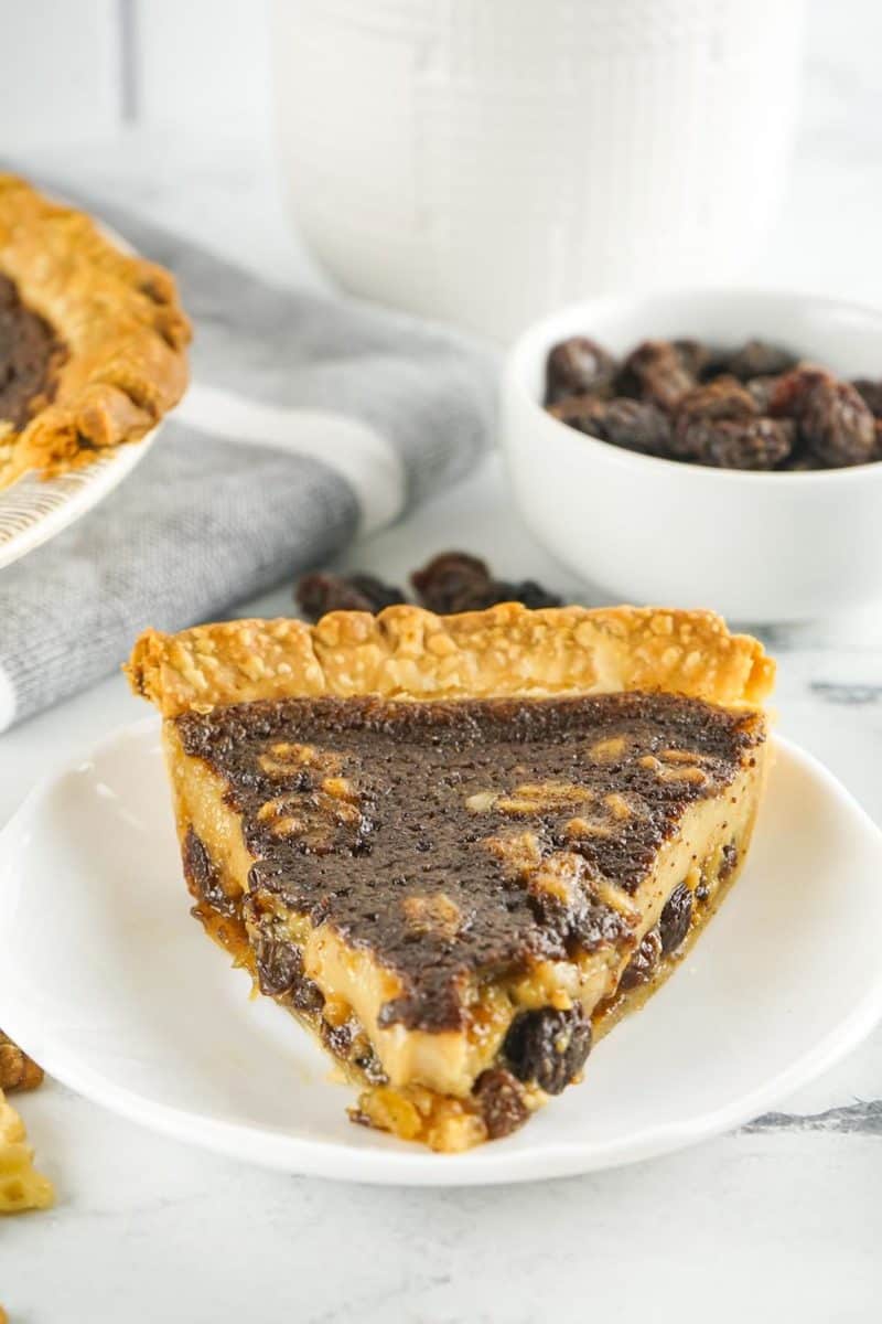 a slice of chess pie with nuts and raisins.
