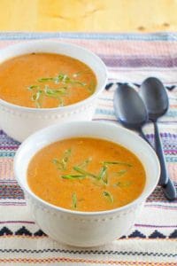 two bowls of chicken enchilada soup and two spoons.