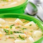 closeup of a bowl of corn chowder with potatoes.