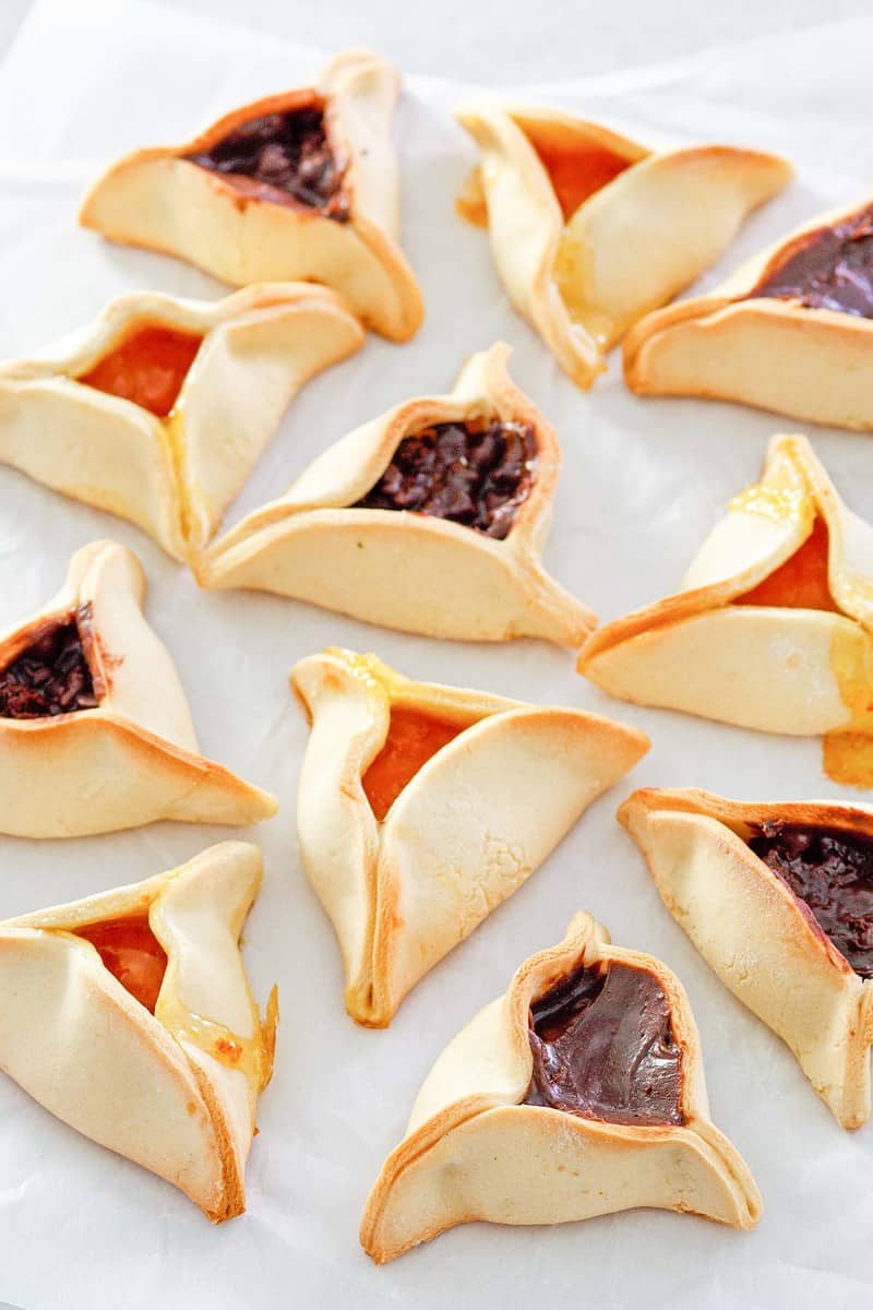 Hamentashen on parchment paper.