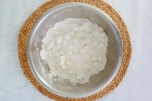 biscuit flour mix and butter cubes in a mixing bowl.