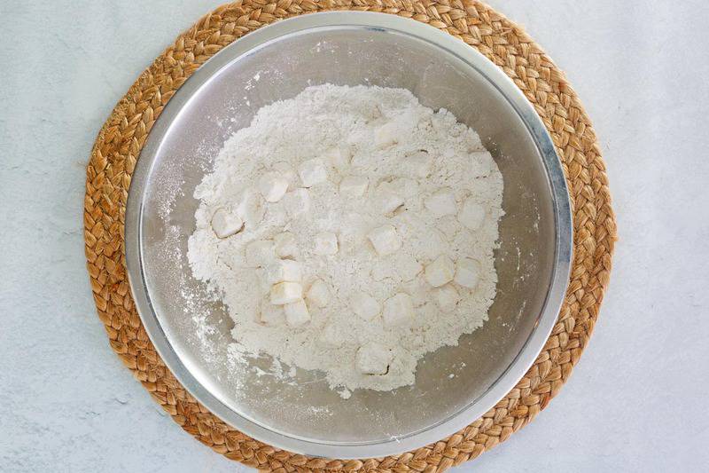 biscuit flour mix and butter cubes in a mixing bowl.