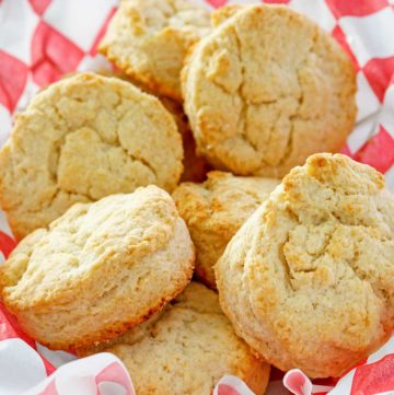 copycat KFC buttermilk biscuits in a parchment-lined basket.